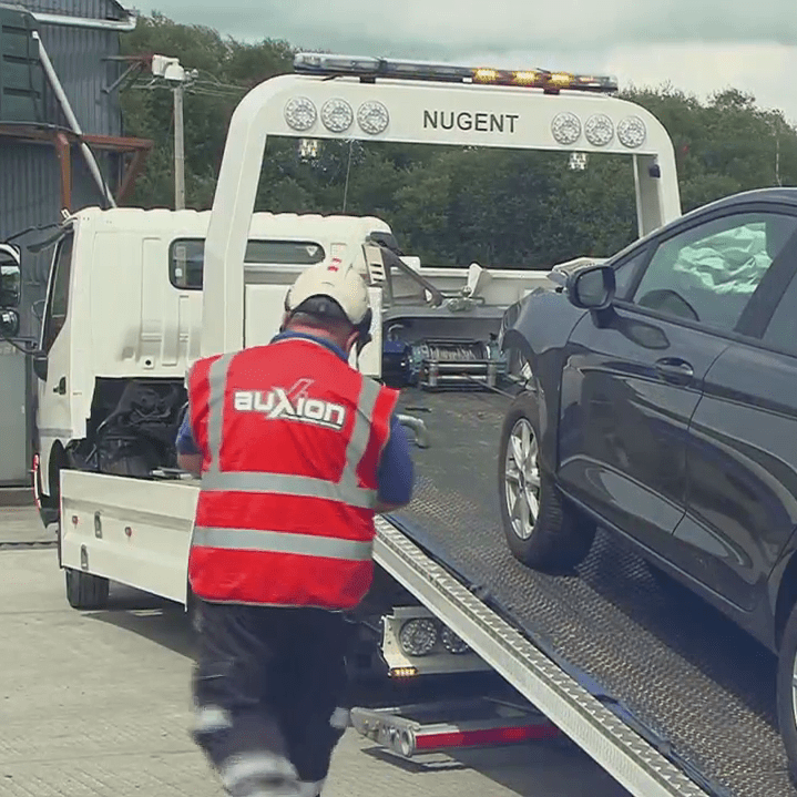 Engineer unloading a vehicle from a maintenance transporter